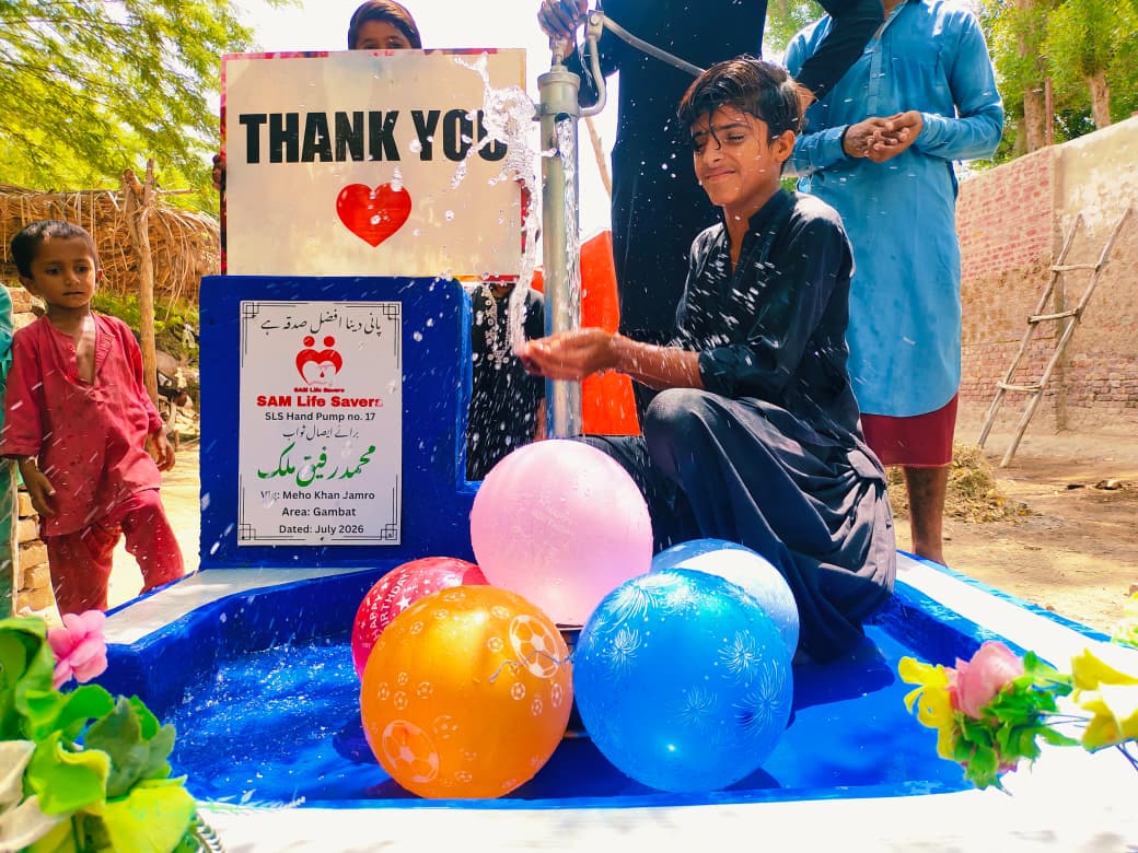 Children celebrating at a newly installed hand pump in Tharparkar, Pakistan, providing clean drinking water through a community water donation project.